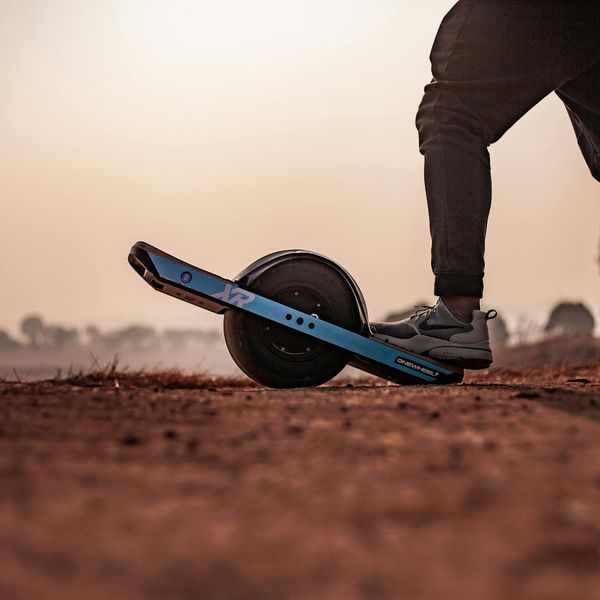 Silhouette of a man in a complex balance pose at sunset.